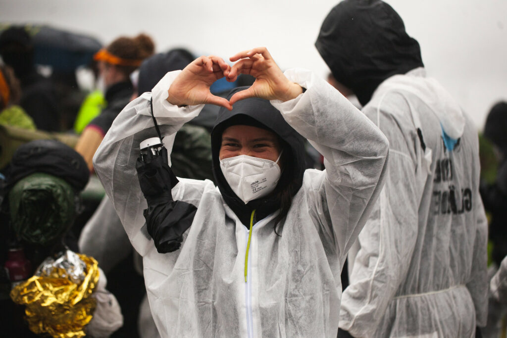 Activist shows a heart with their hand.